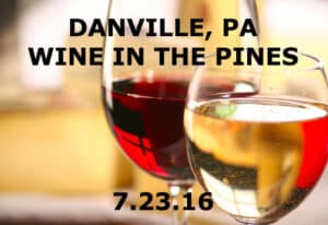 closeup of 2 wine glasses - 1 with red, 1 with white wine Text: Danville PA Wine in the Pines