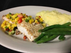 MahiMahi with salsa green beans and mashed potatoes on white plate