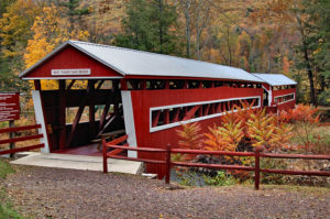 East & West Paden Covered Bridges - two red bridges with white trim end to end over stream