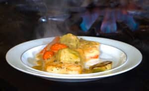 Chilean Sea Bass with artichokes and tomatoes in Limoncello Cream Sauce