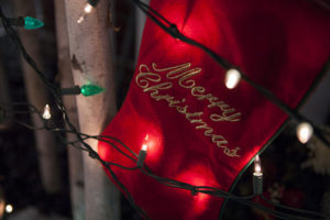 Red Christmas Stocking with 'Merry Christmas' embroidery & Christmas lights in front