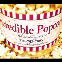 red and white bucket of buttery popcorn says "Incredible Popcorn"