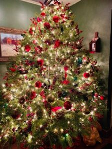 christmas tree with white lights red balls and red ribbons