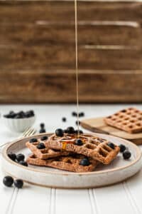 Maple syrup pouring on waffles with blueberries Photo by Lindsay Moe on UnSplash