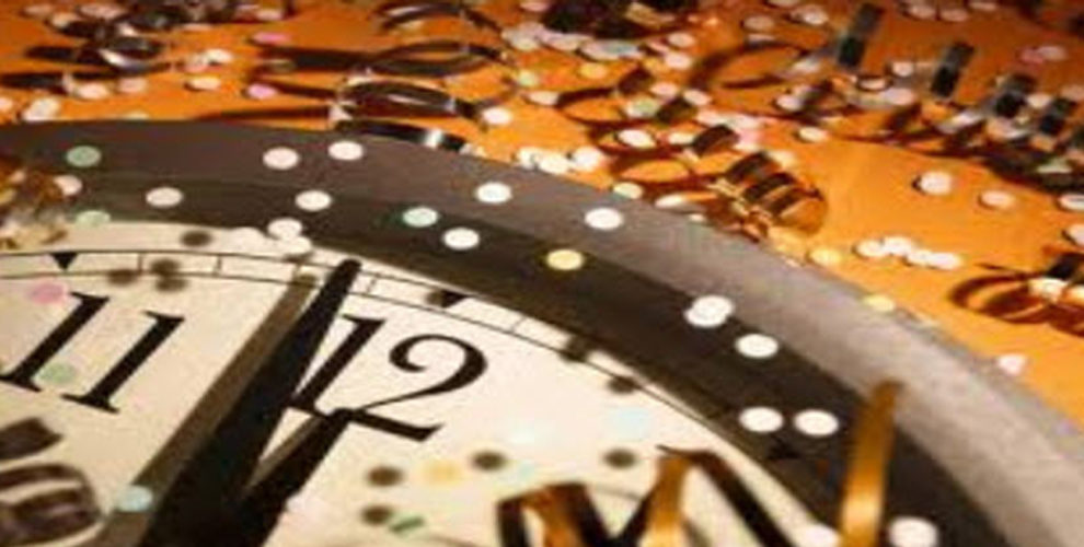 quadrant of clock with hands approaching midnight surrounded by confetti and gold ribbons