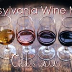 Four glasses of wine on a barrel, with tetx: Pennsylvania Wine Month - October 2020