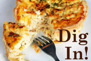 upside down fork on white plate with quiche "Dig In!"