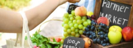 woman making a purchase at a farmers market