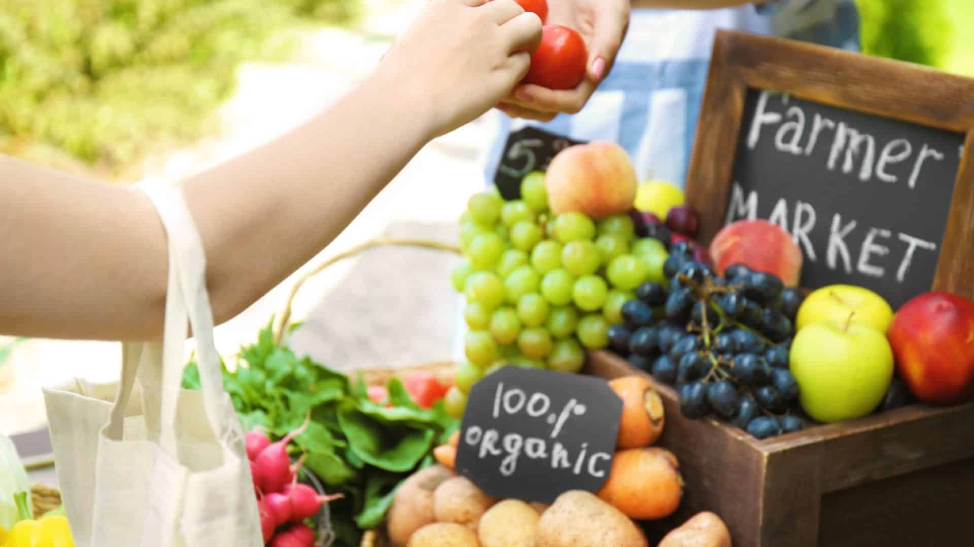 woman making a purchase at a farmers market