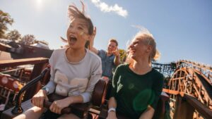two friends riding a roller coaster together