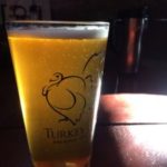 glass of Turkey Hill Brewing Co beer on bar